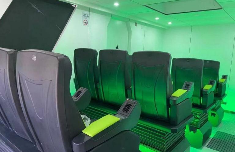 Row of advanced passenger seats inside LUBAN CABIN C30, equipped with personal consoles, highlighted in green lighting